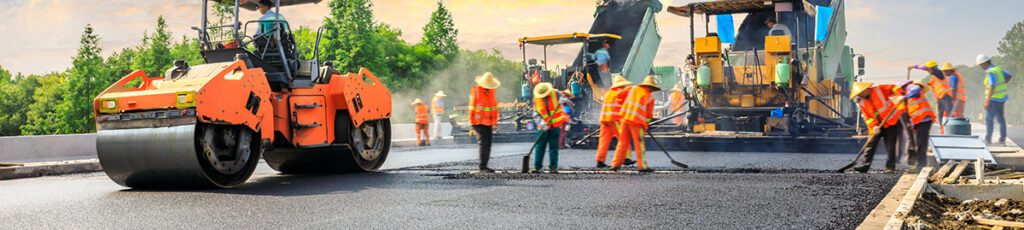 A crew laying new asphalt for a city road.