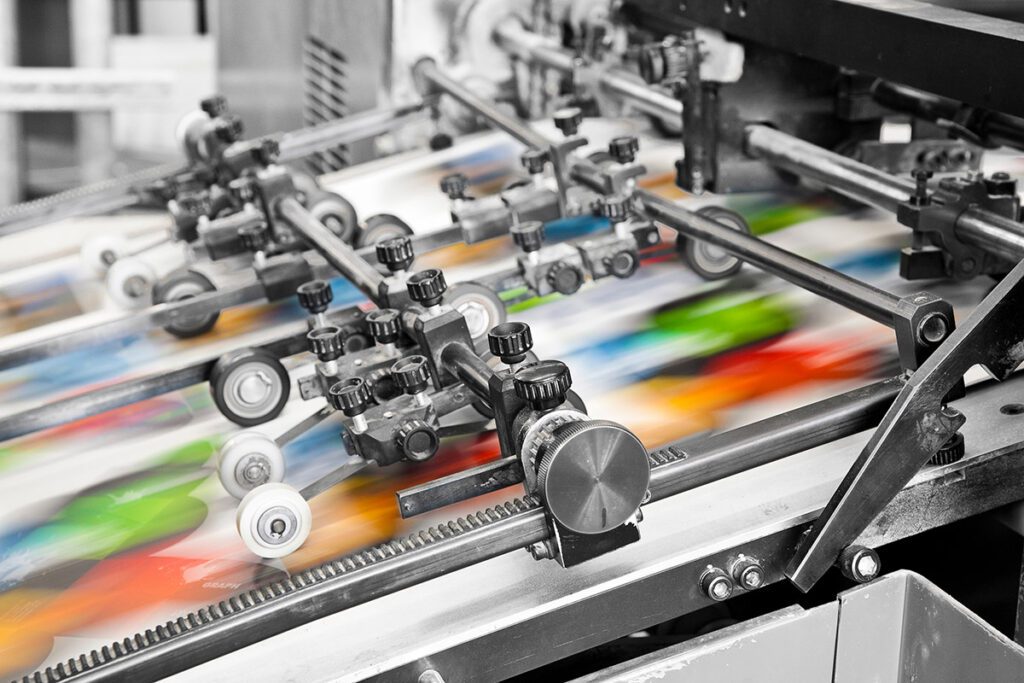 A printing machine producing multiple copies of the same asset at high speed.