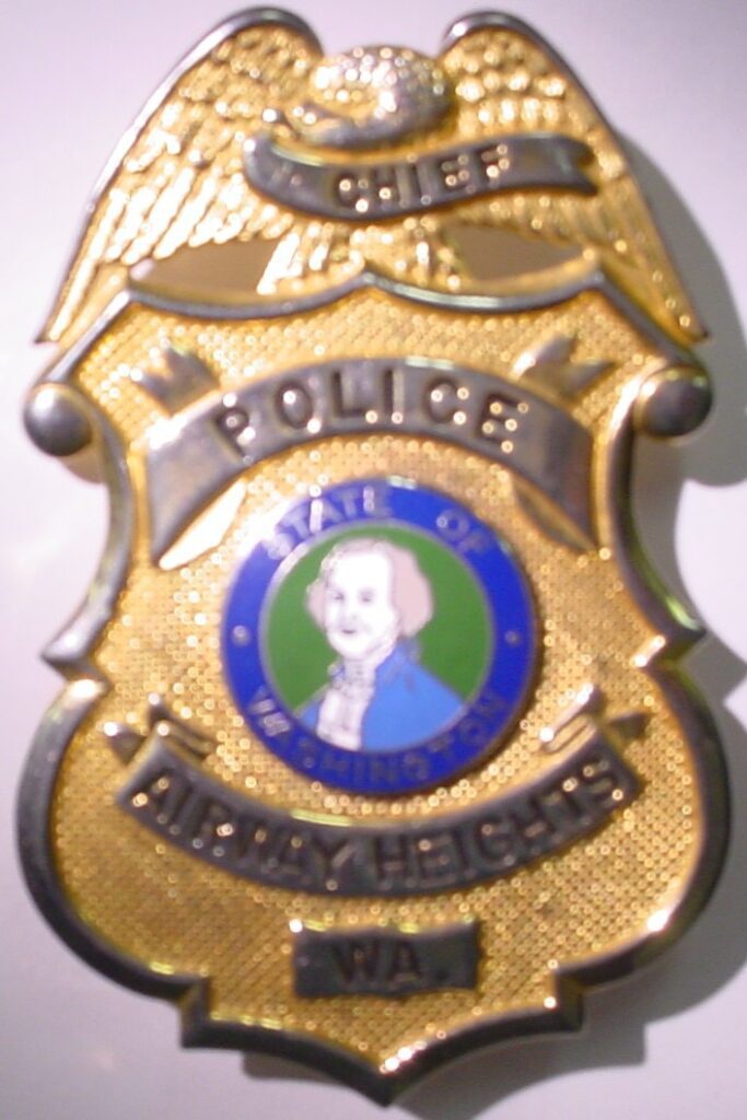 A Blurry image of a gold-plated Police badge.