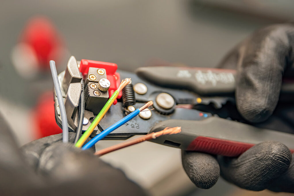 An electrician stripping wires.